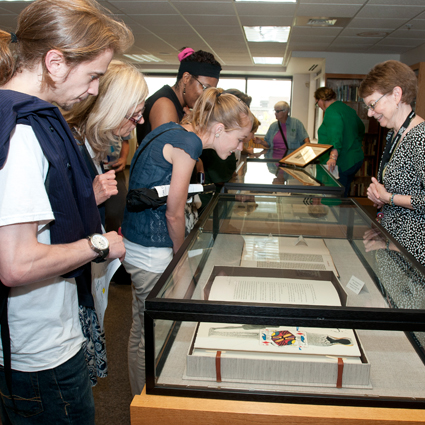 group examining items in glass display